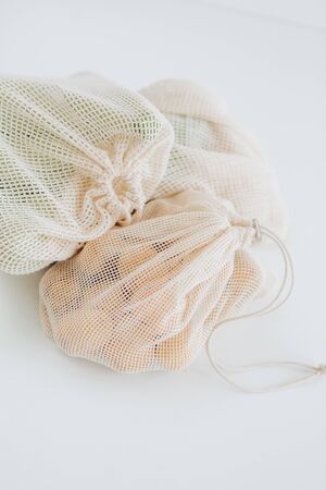 set of products in eco mesh white bag potatoes zucchini saladの写真素材