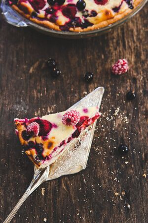 homemade fruit berry pie on a metal shovel on a wooden backgroundの写真素材