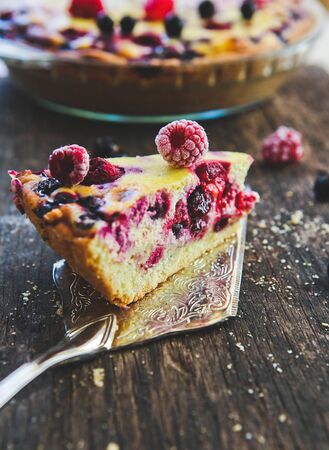 homemade fruit berry pie on a metal shovel on a wooden backgroundの写真素材
