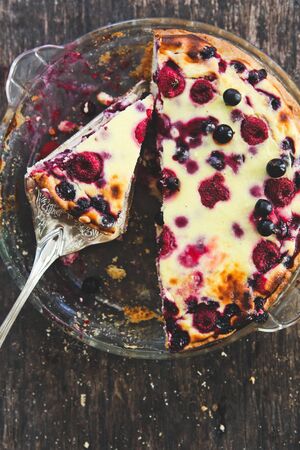 homemade fruit berry pie on a metal shovel on a wooden backgroundの写真素材