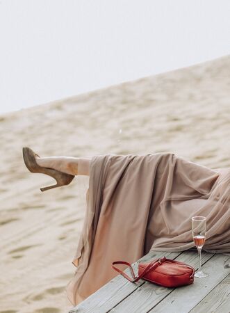 girls in beautiful dresses and heels on the beach seaside leisure tourism travelの写真素材