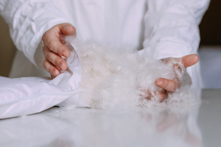 white natural fluff on the table and in the hands of an employee in a clean uniform