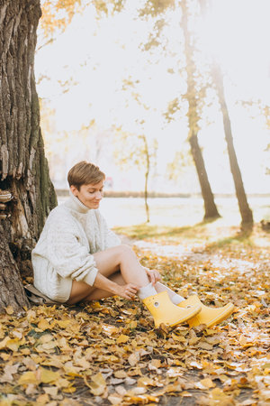 autumn yellow leaf fall conceptual girl in the parkの写真素材
