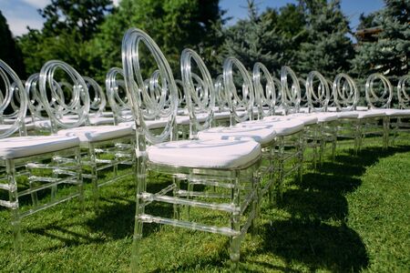 decorative transparent plastic chairs for events outside are arranged in a semicircleの写真素材