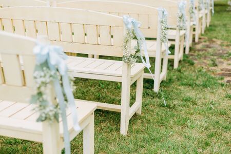 wedding decor flowers postcard chairs ceremony arch terrace party guests outsideの写真素材