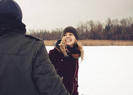 couple in love joyful winter snowy outside playful happinessの写真素材