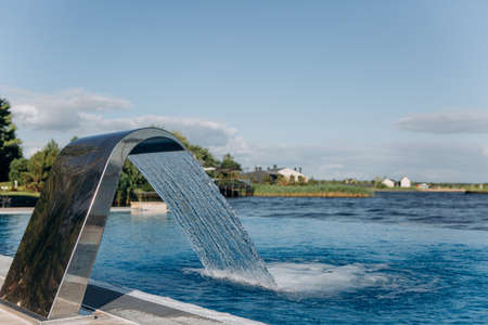 artificial waterfall modern style stainless steel in the pool by the riverの写真素材