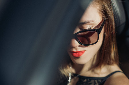 fashion stylish girl in sunglasses driving a car lifestyle