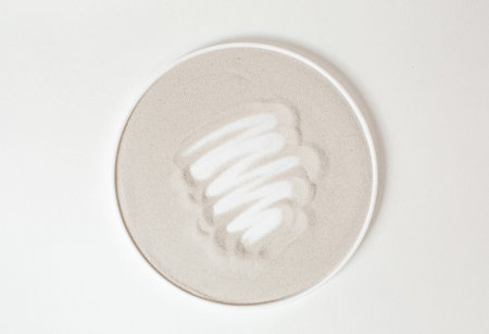 circle beige with strokes of white cream in the center