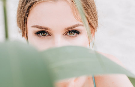 look of the girl affirming a clean face a plant in the desertの写真素材