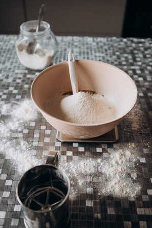 sifted flour in a bowl on a table for making breadの写真素材