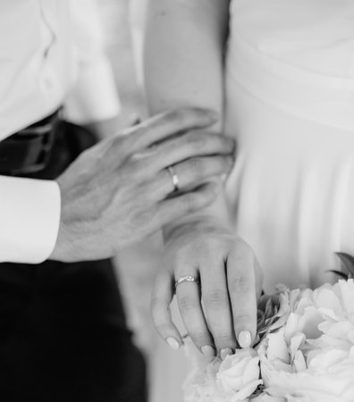 hands of the bride and groom together tenderness couple in love wedding storyの写真素材