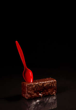 cake sweets pastries beautiful in chocolate glaze red on a black background top viewの写真素材