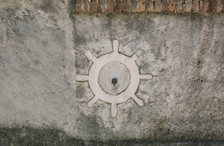ship steering wheel on a concrete wall partition texture 3d