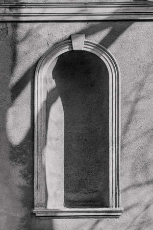 ancient architecture on the walls arch window structure concrete shade sunの写真素材