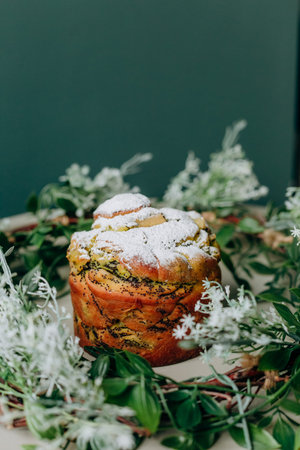 Easter baked goods filled with poppy seeds and raisins and sprinkling with powder with spring decor