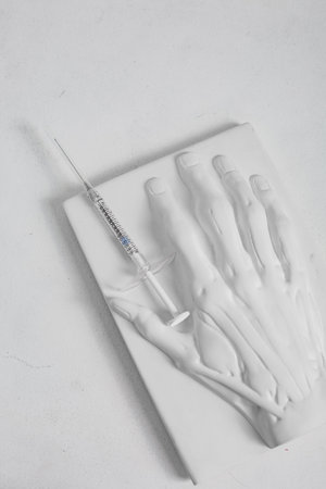 plaster mock up of human hand with veins and syringe medical cosmetology concept