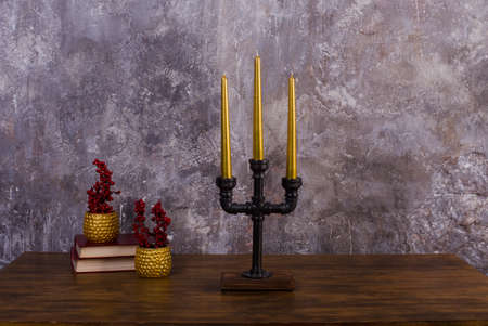 candlestick for three candles metal loft style and gold candles design interiorの写真素材