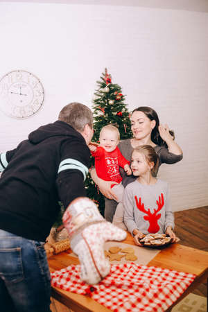 happy family celebrating new year house with christmas treeの写真素材