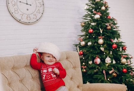 little girl playing with santa claus hat christmas symbols