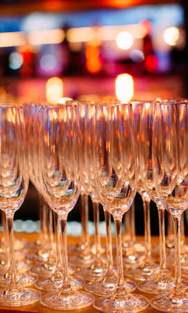 lot of glasses glitter on the background of colorful garlands festive partyの写真素材