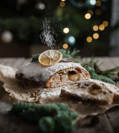 stollen cut with ornaments holiday decor christmas tree garlands bokehの写真素材