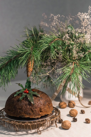 decorated Christmas stollen on a figured stand with spruce branches