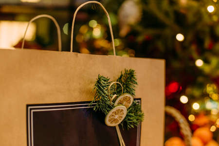 craft package gift holiday under the christmas tree with garlandsの写真素材
