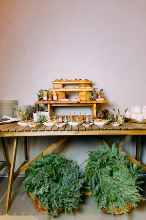 table shelves with snacks and christmas decor pine wreaths