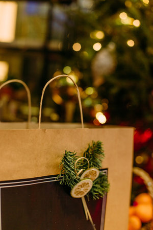 craft package gift holiday under the christmas tree with garlandsの写真素材