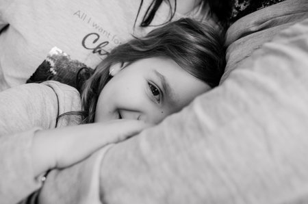 happy girl lies on the pillow after sleep closed her eyesの写真素材