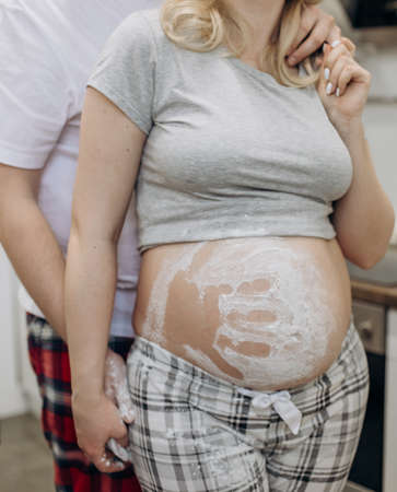 pregnant woman and husband hug hand trace from flour happy familyの写真素材
