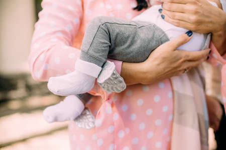 woman holds a sleeping baby tightly in her arms anxiety, experience for the life of a childの写真素材