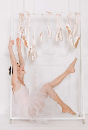 beautiful girl ballerina doing leg warm up model in the studioの写真素材