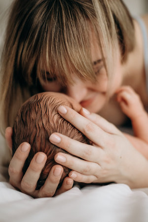 mother and newborn baby in her arms birth new life humanity light religion