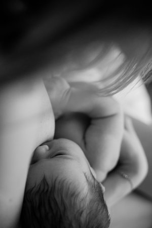 mother and newborn baby in her arms birth new life humanity light religion