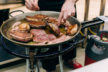 raw meat pork pan frying cooking kitchen restaurantの写真素材
