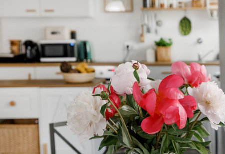 Bright Scandinavian Kitchen Interior Dining Table Peonies Flowers Vaseの写真素材
