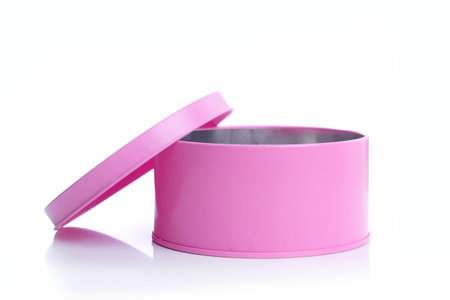 pink metal round open box on whiteの写真素材