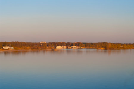 Lake at sunset with a thin strip of shore. Autumn coast on the plain.の写真素材