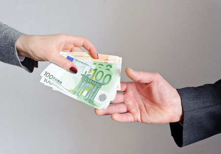 Female hand gives money, the manの写真素材