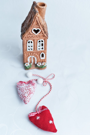 Two soft heart and Terracotta house on a white backgroundの写真素材