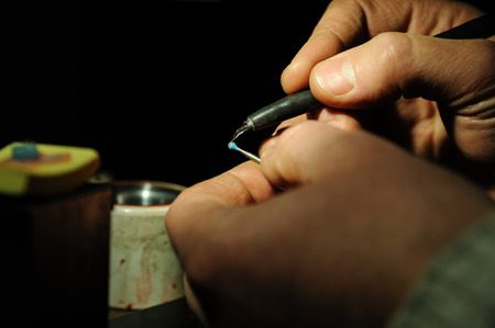 Craft jewelery making. Jeweller creates a wax model mount for the gem.の写真素材