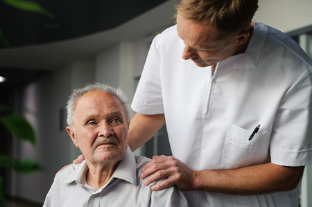 Healthcare worker is asking the elderly man about his state of health.の写真素材