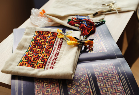 Still life embroidery. Drawing, thread, pattern are included on the tableの写真素材