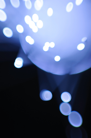 Abstract blue flashing lights on a dark backgroundの写真素材