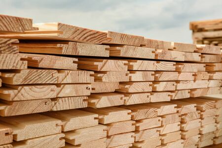 End view of stacked lining board. Wooden structure closeup.の写真素材