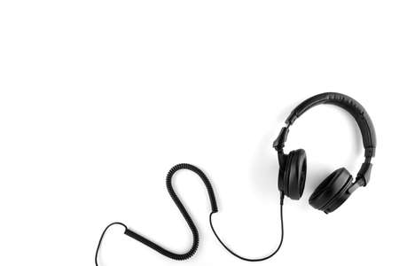 Black headphones with a wire on a white background.の写真素材