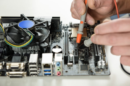 A technician checks the serviceability of the computer motherboard.の写真素材