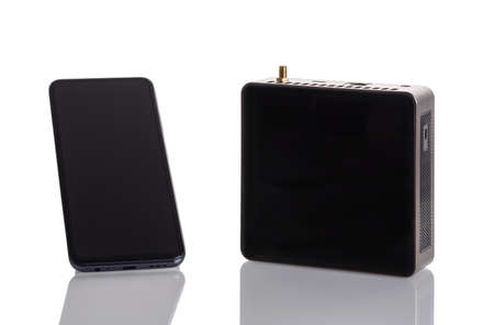 Smartphone and wireless hotspot for helium token mining on white background.の写真素材